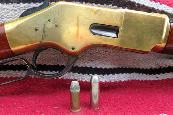Shown with the action of an 1866 replica are the 44 Henry and 44-40 cartridges.